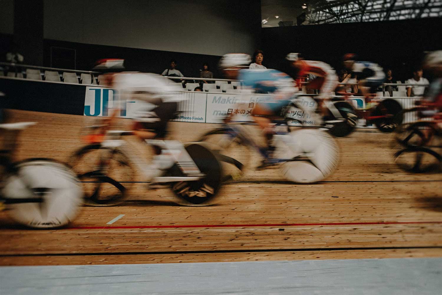 Blurred image of multiple track cyclists during Japan National cycling event at Izu Velodrome
