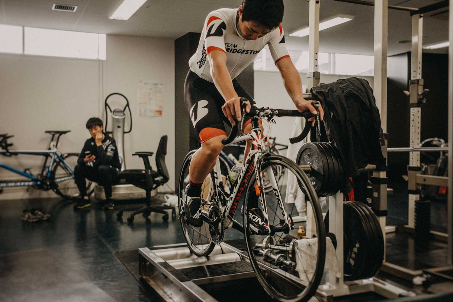 Japan Olympic track cyclist trains on static rollers to test cycling foot orthotics at Izu Velodrome, Japan